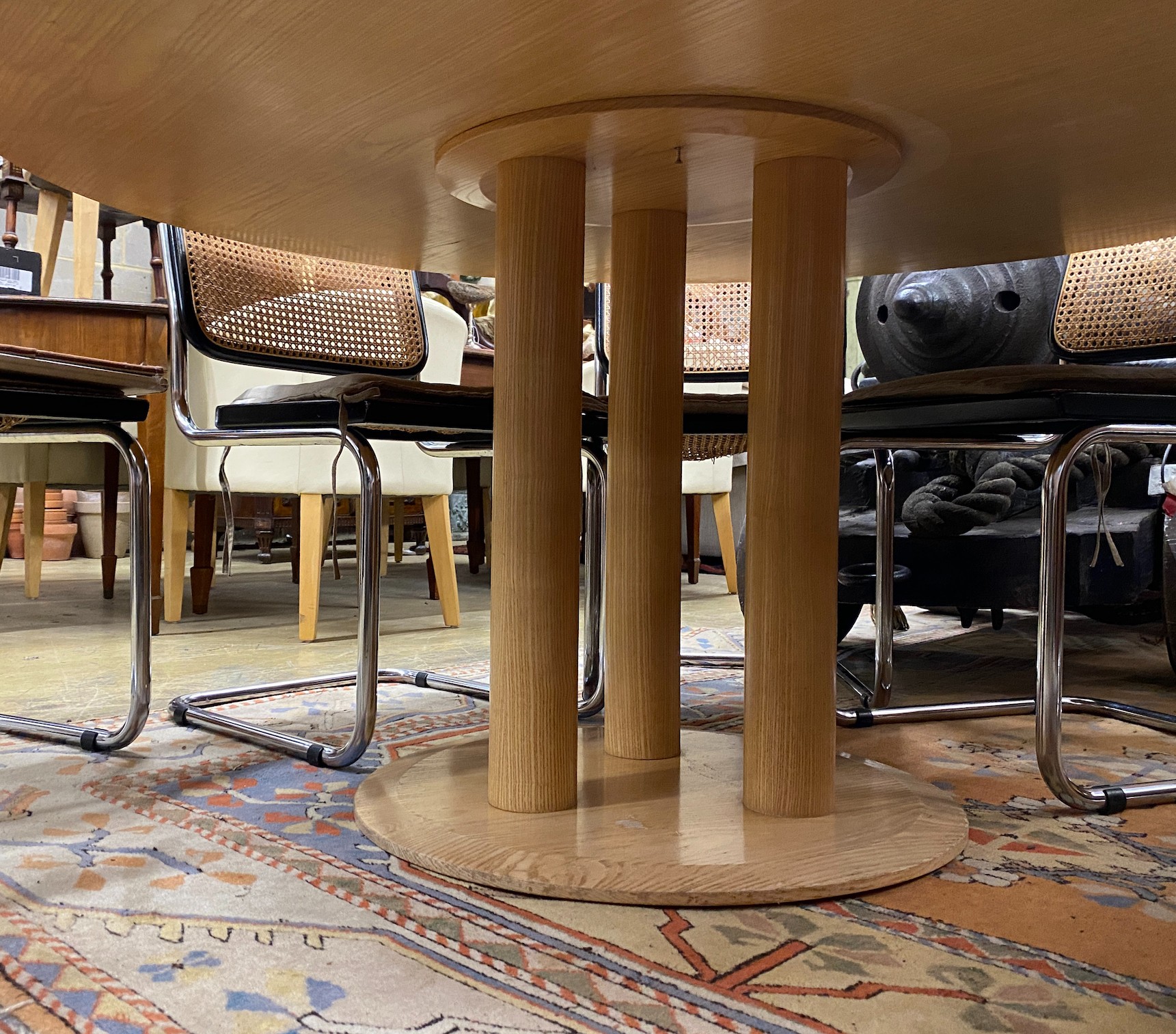 A Conran retailed circular pale ash dining table, on three pillars and circular plinth foot, diameter 150cm, height 73cm